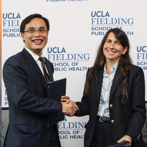 Dean Jody Heymann (right) signed a Memorandum of Understanding with Dr. Luqi Huang of the China Academy of Chinese Medical Sciences.