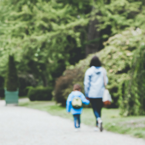 Mom and child walking along street