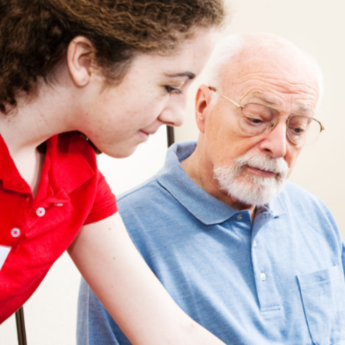 volunteer helping an elderly person