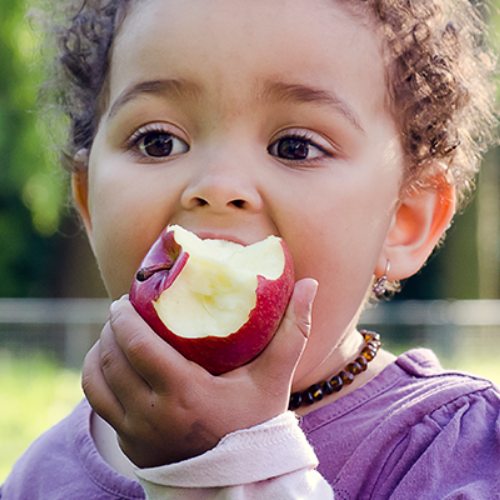 child eating an apple