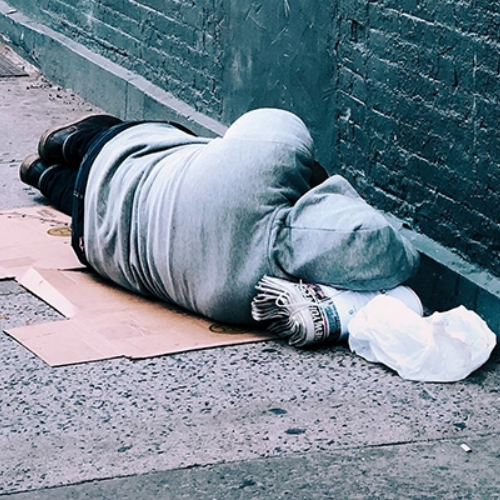 unhoused person lying on the floor