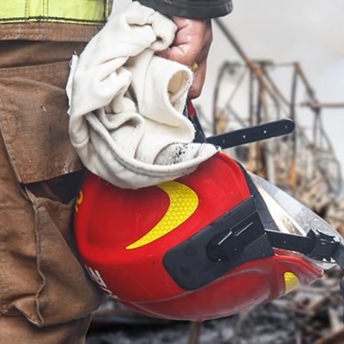 emergency relief worker holding a helmet