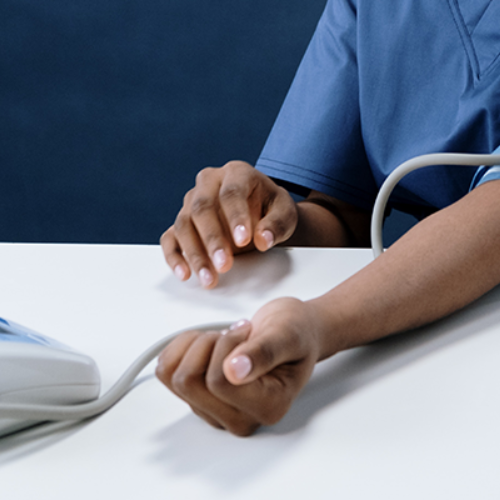 person with blood pressure machine