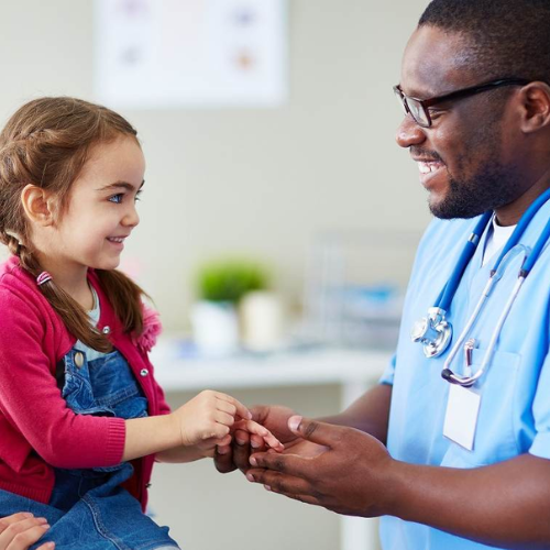 doctor helping young child patient