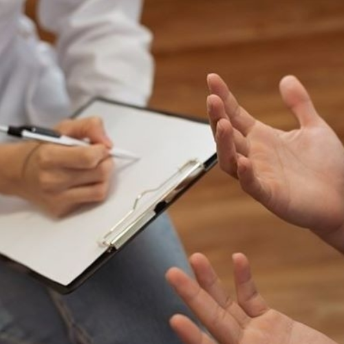 hands and a clipboard