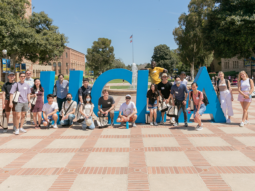 students posing in front of the words UCLA