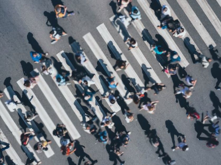 People walking through a busy crosswalk