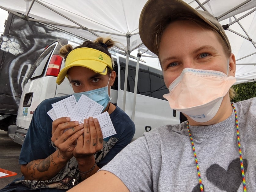 Dr. Chelsea Shover (right) with Gunner Sixx, a coordinator with Housing for Health, at a vaccination event at St. Francis Center in Downtown Los Angeles in August 2021.