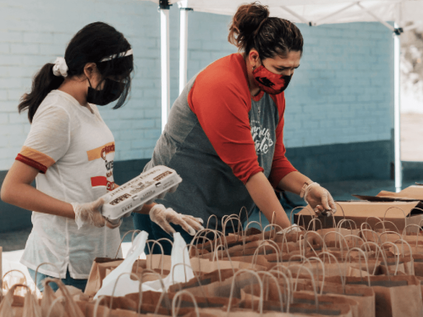Two women packing lunches