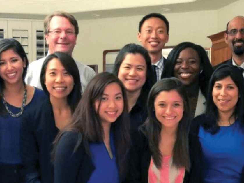 students and professor smiling 