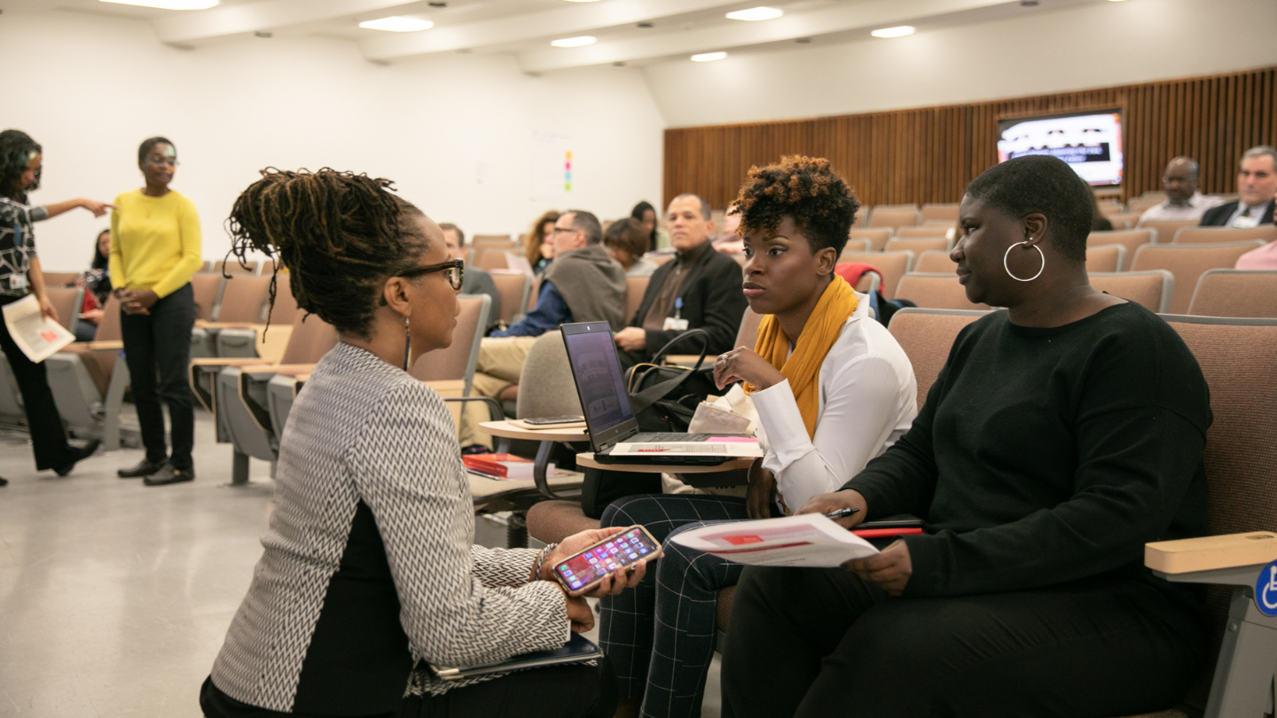 professor and students speaking in lecture hall