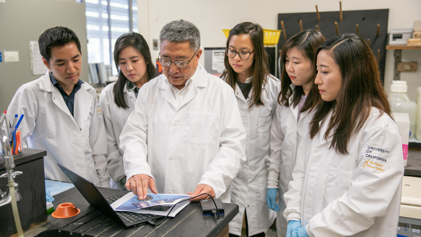 students and professor in lab