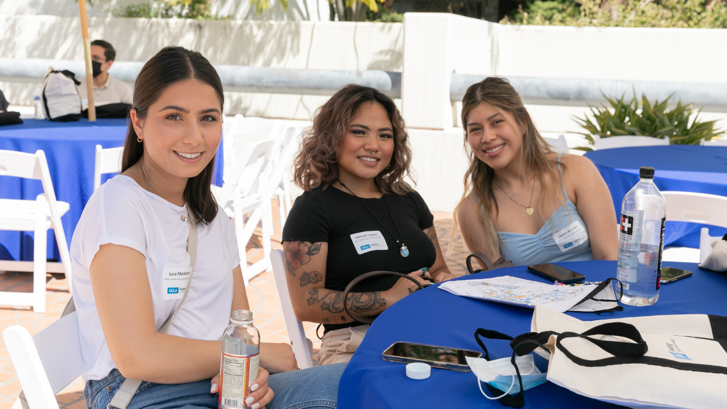 students sitting at table smiling