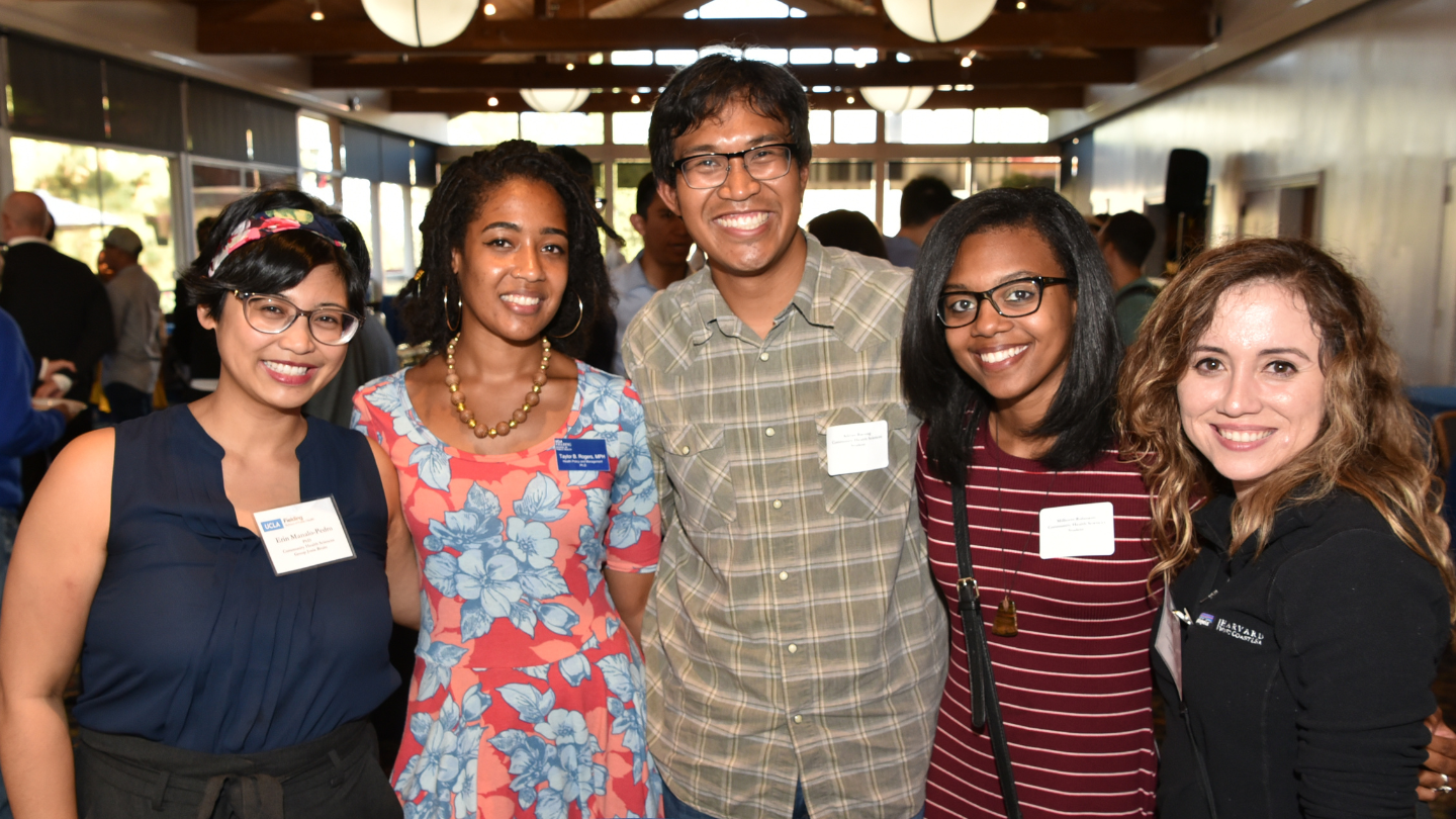 students standing smiling at reception