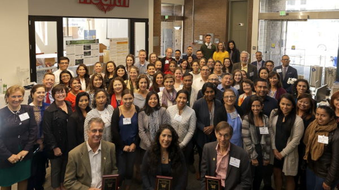 Wallace (front row, right), a recipient of the inaugural Mario Gutierrez Champion of Migrant Health Award at the Health Initiative of the Americas' Annual Migration and Health Summer Institute in 2018